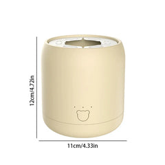Milk Shaker - Beige cylindrical device with bear face detail, marked 12cm tall and 11cm wide, with a slotted top insert.