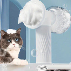 Automatic Foaming Pet Bath Brush Dispenser - Gray and white cat with foam on its head sits next to a white foaming pet brush with floating bubbles and a folded towel
