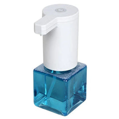 Soap Dispenser - White automatic pump top with blue square glass bottle on plain white background