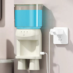 Wall-mounted mouthwash dispenser plugged into a wall socket, with a translucent upper water tank and two cups at the bottom.