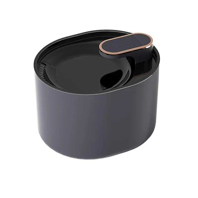 Dark gray rounded oval pet water fountain with black top basin and rose gold accented outlet spout