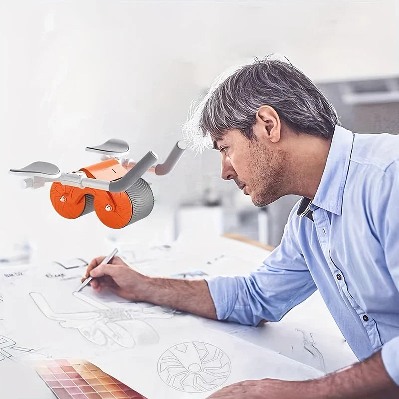Ab Roller Wheel - Gray-haired man in light blue shirt draws on paper with a pencil; an orange and gray dual-wheel device hovers nearby.