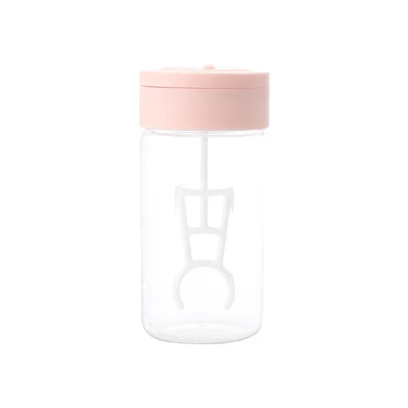 Automatic Mixing Mug - clear body with pink lid and internal stirring paddle, front view on white background