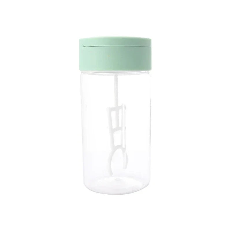 Automatic Mixing Mug - Full view of a clear plastic electric blender cup with a mint green lid and white internal blending stirrer, on a white background