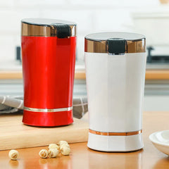 Coffee Grinding Machine - Red and white electric grinders on wooden kitchen counter with dried seeds nearby