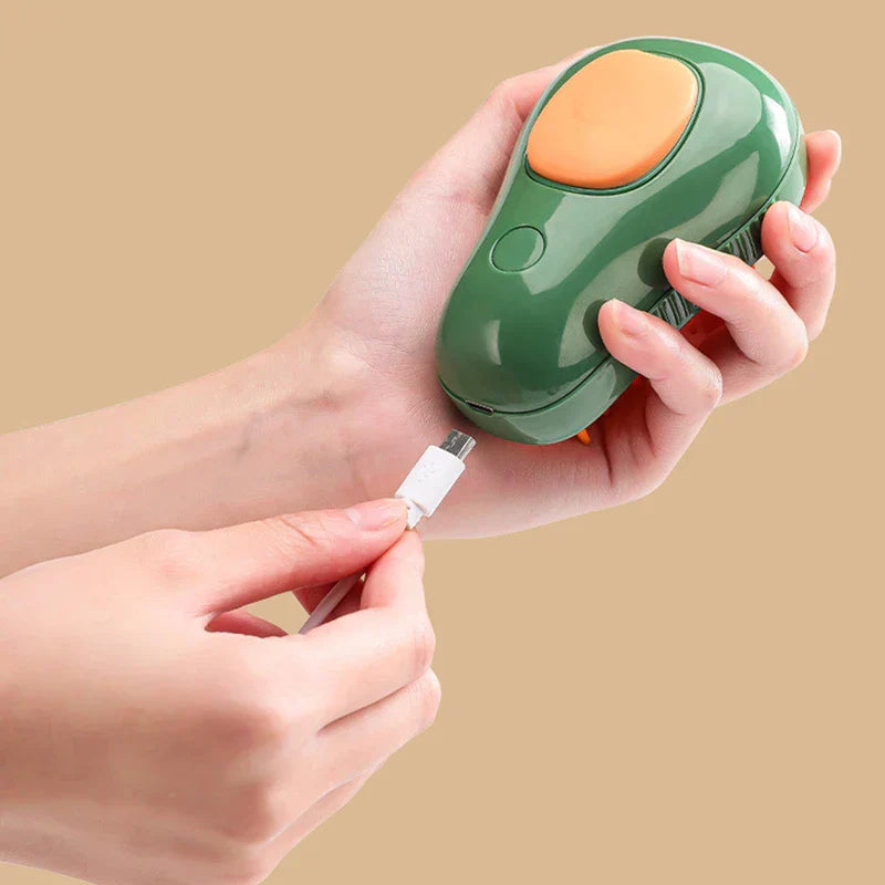 Pet Grooming Brush - Two hands hold a green avocado-shaped brush while plugging a white micro USB cable into its charging port.