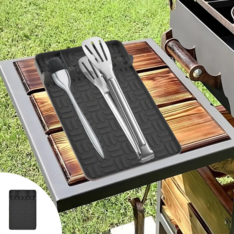 Bbq Grill Tool Rest Mat - Black tool rest mat on outdoor wooden side table holding stainless steel grilling utensils