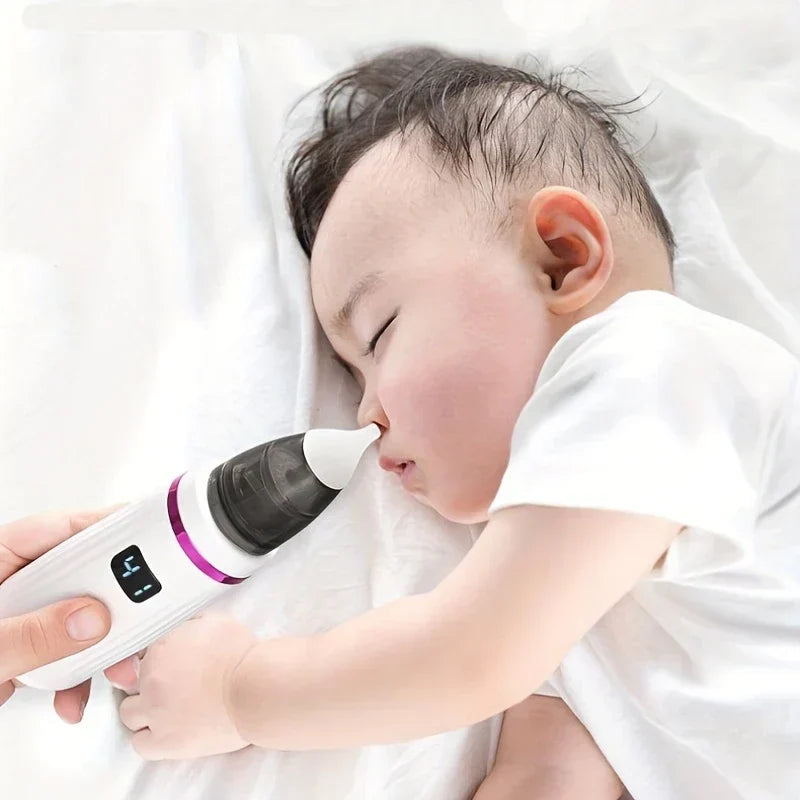 Snot Sucker - Adult holding nasal aspirator near sleeping baby's nose on white bedding