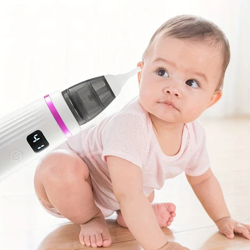 Snot Sucker - Electric baby nasal aspirator positioned near a crawling infant in a pink outfit on a wood floor