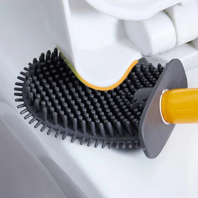 Bathroom Toilet Bowl Brush - Close-up of a silicone toilet brush head cleaning the edge of a white toilet under the seat.
