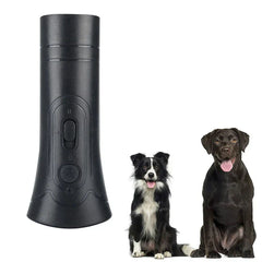 Dog Training Clicker - Black handheld training device next to two sitting dogs (border collie and chocolate lab), white background
