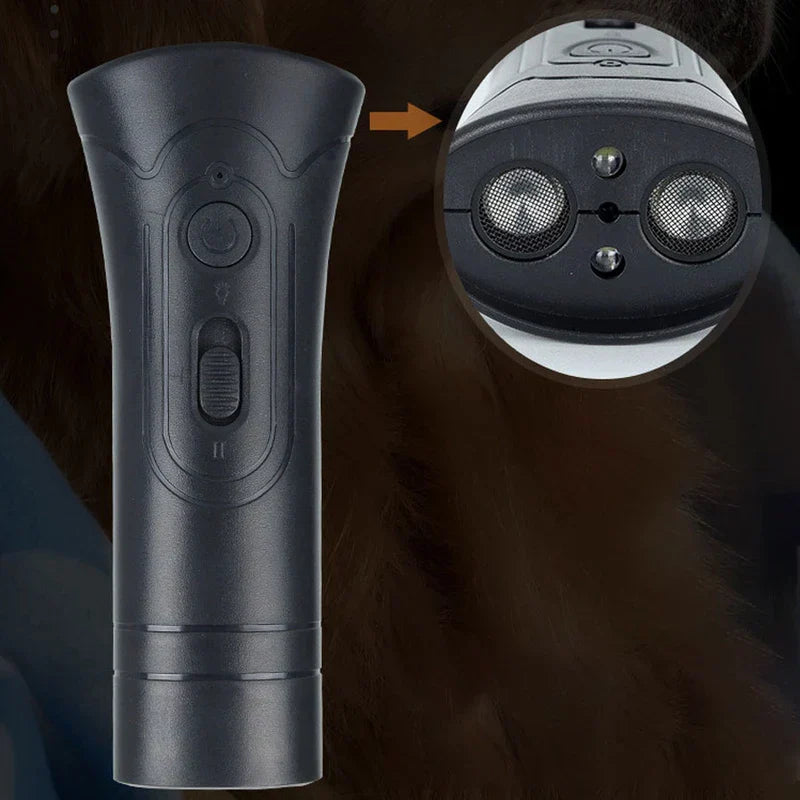 Dog Training Clicker - Black handheld training device with close-up inset of top speaker and light components, dark fur background
