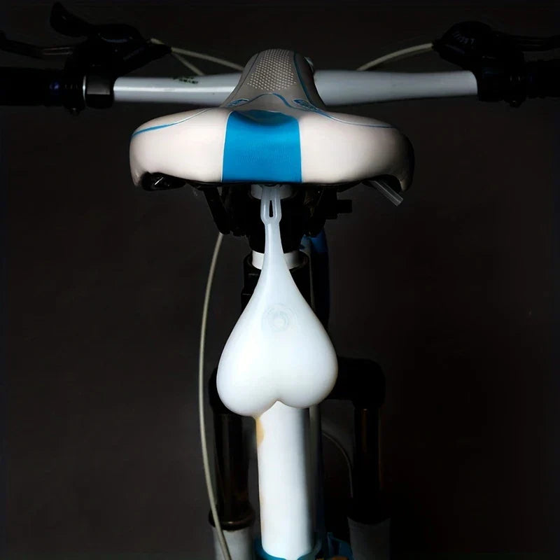 Led Bike Tail Rear Light - light attached to bicycle seat post, viewed from behind against dark background
