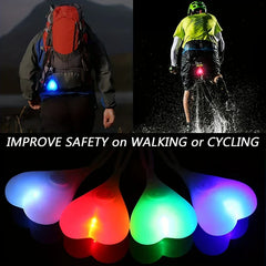 Led Bike Tail Rear Light - Split image: left person hiking with blue heart light on backpack, right cyclist with red heart bike light, bottom row of four colored glowing heart lights