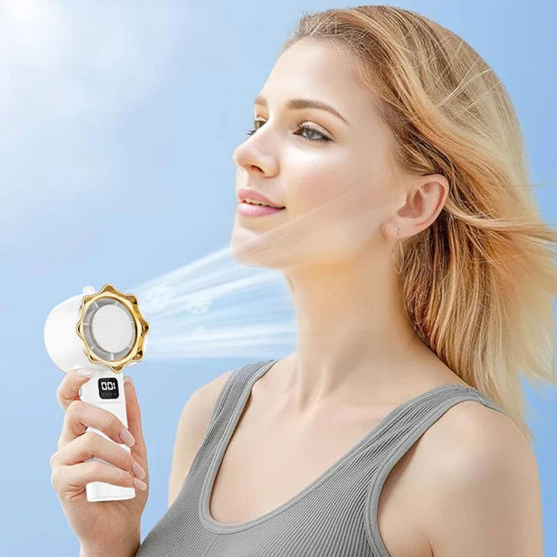 Personal Cooling Fan - Person holding handheld fan with visible airflow directed toward face outdoors