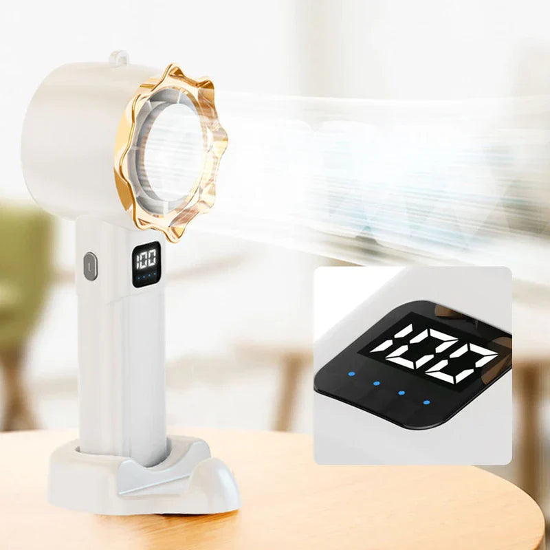 Personal Cooling Fan - White handheld bladeless fan with gold front ring resting on its base, with wind effect lines, and a close-up inset of its digital display showing 100