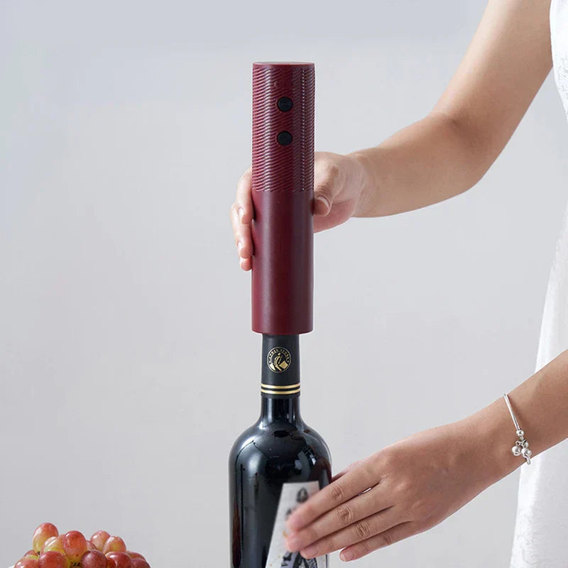 Wine Bottle Opener - Hand holding burgundy opener positioned on top of a red wine bottle