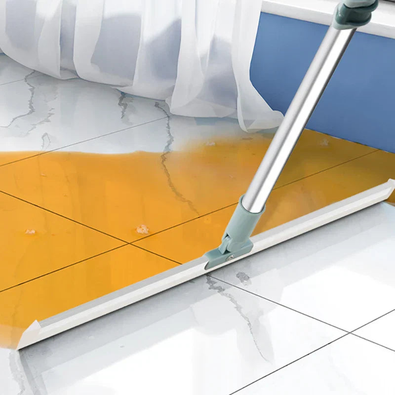 Broom Dustpan Set - sweeper cleaning tool pushing liquid spill across marble-patterned tile floor near curtain and blue wall trim