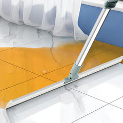 Broom Dustpan Set - sweeper cleaning tool pushing liquid spill across marble-patterned tile floor near curtain and blue wall trim