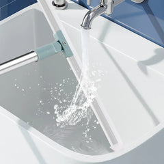 Broom Dustpan Set - sweeper cleaning tool blade being rinsed under running faucet water in a white sink