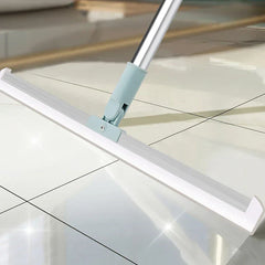 Broom Dustpan Set - Light blue and silver floor squeegee rests on glossy white tiled floor