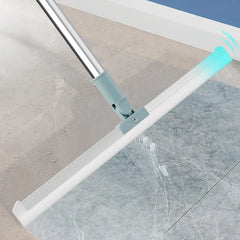 Broom Dustpan Set - Light blue and silver floor squeegee on grey marble-style tile, turquoise end with motion lines near wall trim