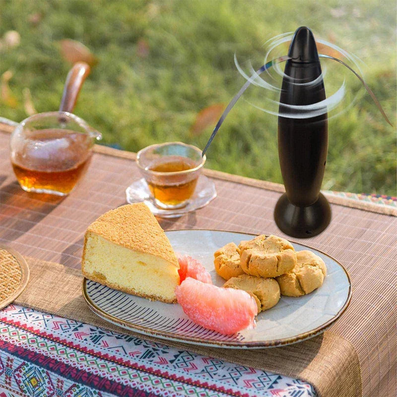 Bullet shape fly repellent fan device on a patio table