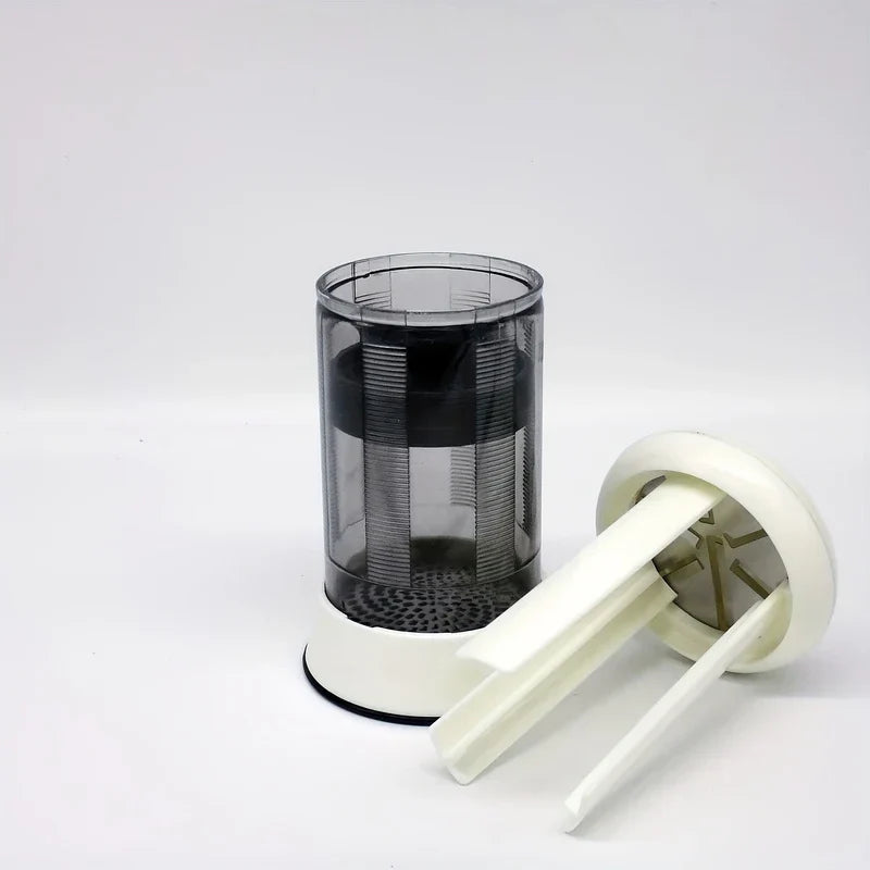 Butter Grater - Cylindrical device with detached white top piece leaning against its translucent body with white base on a white surface