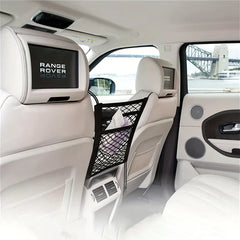 Car Seat Gap Filler Organizer Net - Black elastic mesh organizer with tissues hangs between two front seats inside a Range Rover with white interior