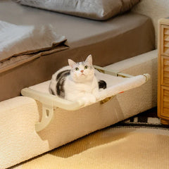 Cat Window Perch - White and gray tabby cat lying on white plush hammock bed attached to a couch arm