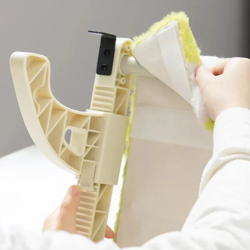 A person's hands adjusting the green plush fabric cover of a beige plastic cat window perch bracket