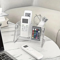 Remote Control Organizer - Clear multi-slot organizer on a marble side table holding remotes, glasses, and a small item