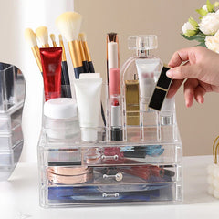 Plastic Storage Container - hand reaching for lipstick stored in top divided section of clear organizer filled with cosmetics