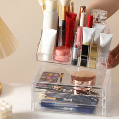 Plastic Storage Container - Clear two-part cosmetic organizer: top section holds brushes, lipsticks and bottles, bottom has three drawers with makeup