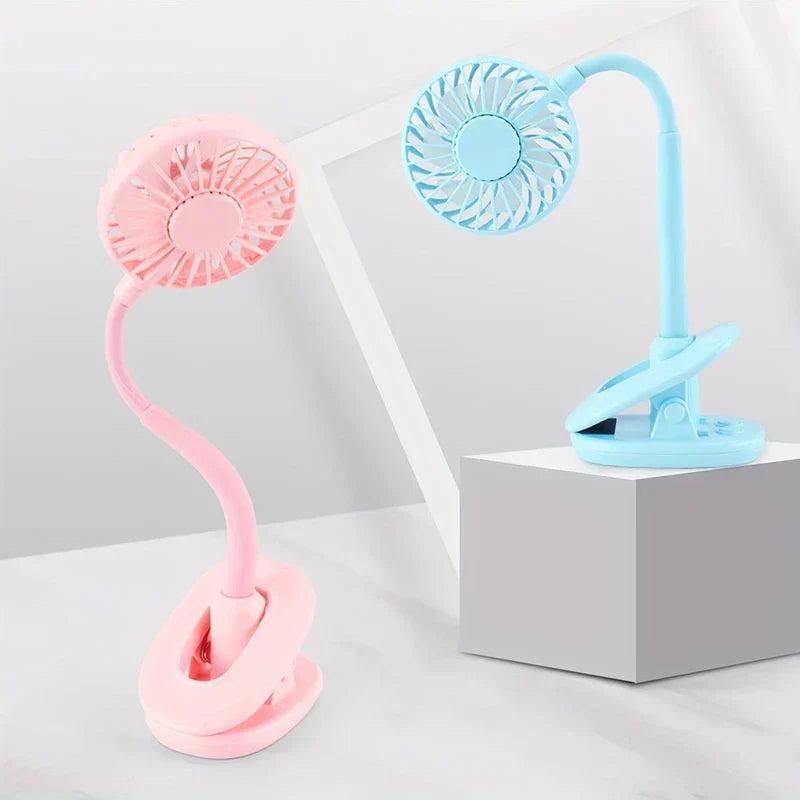 Desk Fan - Pink and light blue clip-on flexible-neck mini fans, one on flat surface one on grey block