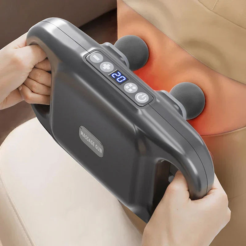 Compact Muscle - Dark gray handheld massage device being used on a person's lower back, held by two hands