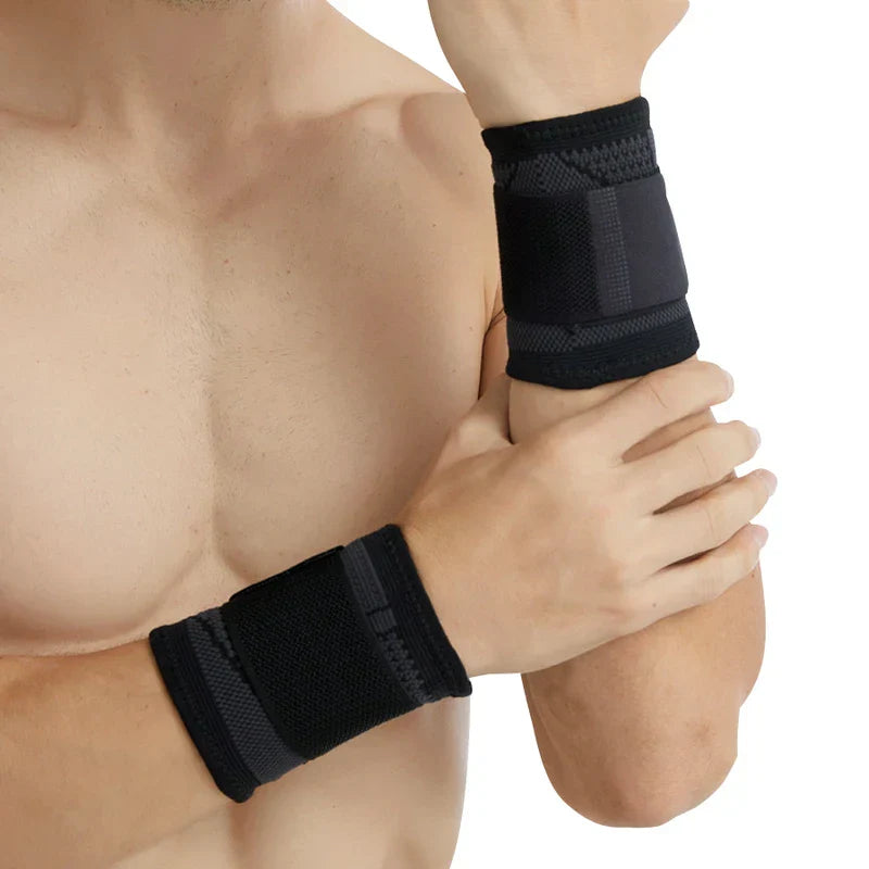 Compression Wrist Brace - Shirtless person with bent arms, wearing solid black adjustable wrist wraps against a white background.