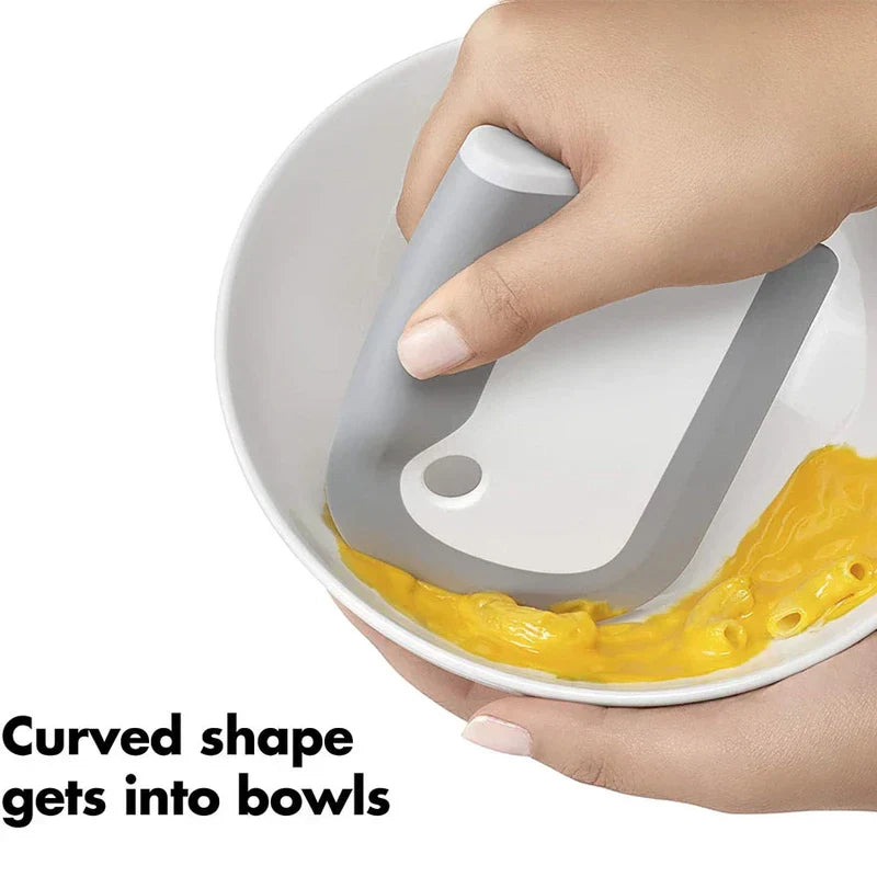 Countertop Dishwasher Machine - Hand holding a curved gray and white scraper cleaning yellow food from inside a bowl, with text 'Curved shape gets into bowls'