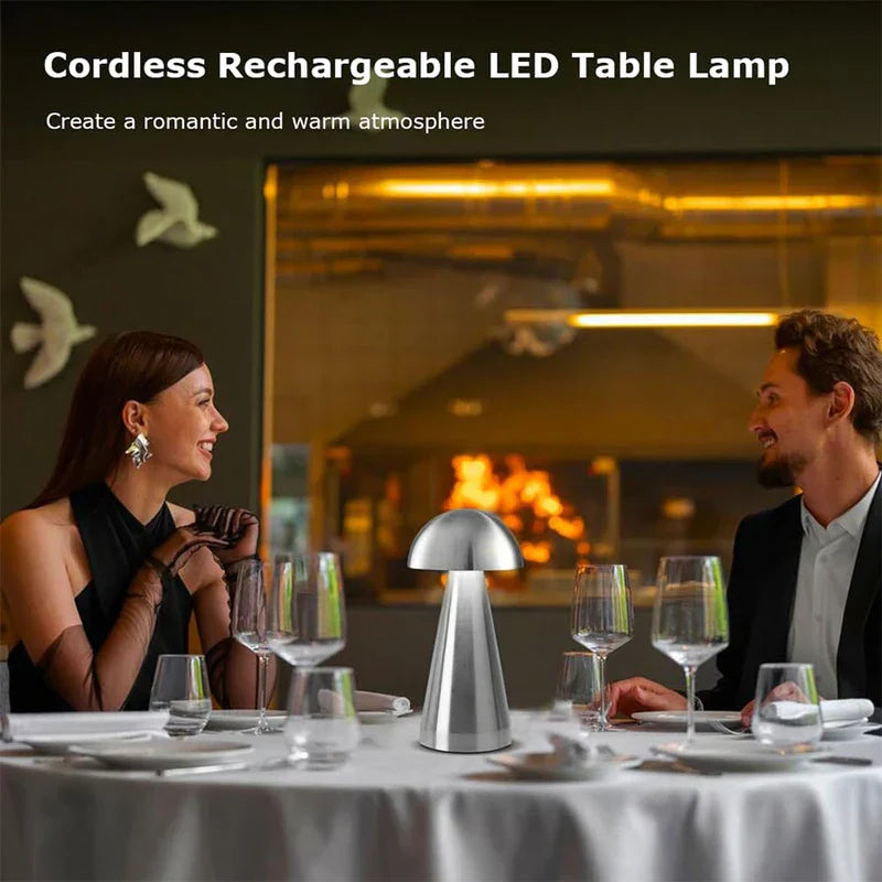 Accent Lamp - Brushed silver mushroom-shaped lamp placed on a formally set dining table between two diners