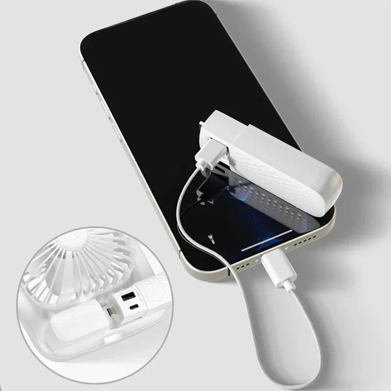 Desk Fan - White clip-on mini fan with built-in power bank attached to a smartphone, charging it via a connected USB cable; inset closeup shows the fan's ports.