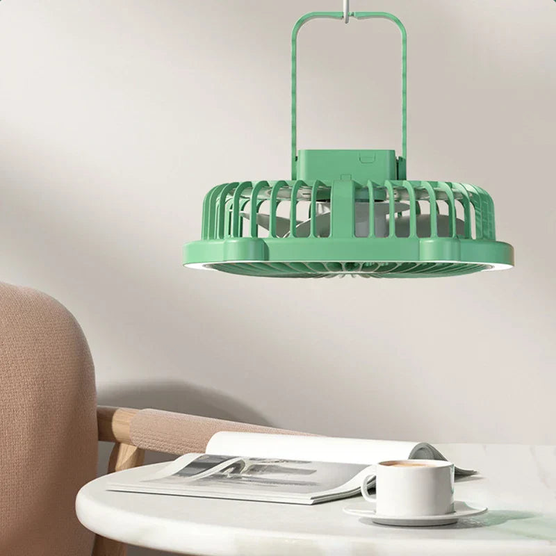 A desktop desk lamp with cooling fan hangs above a round table holding a magazine and coffee cup
