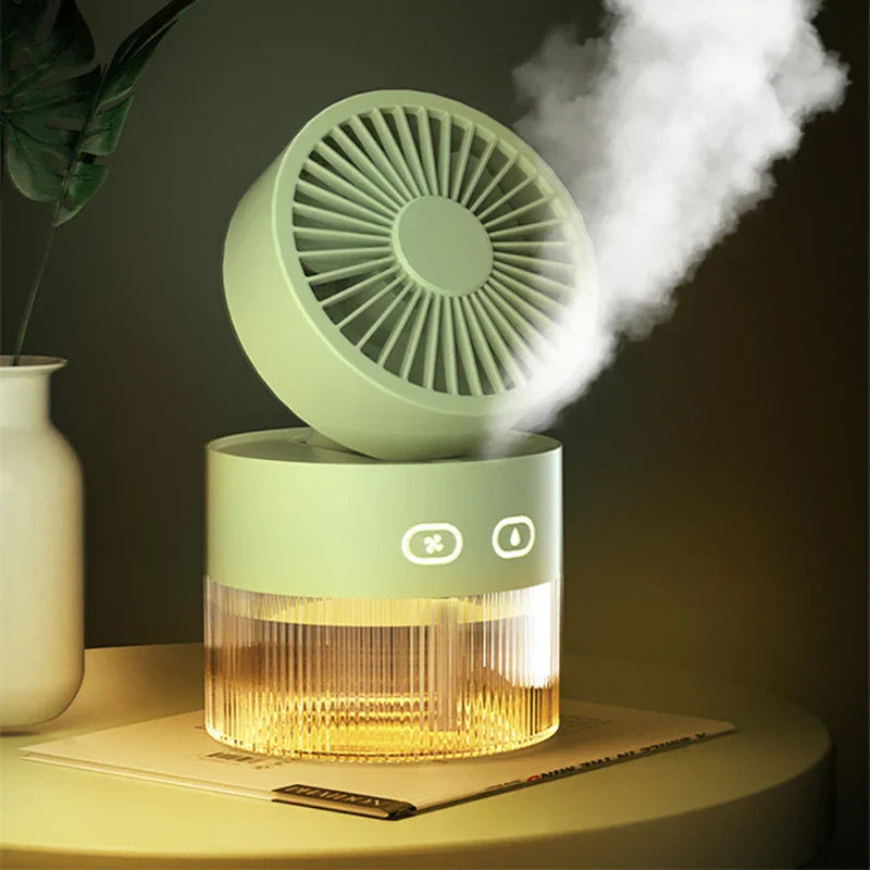 Usb Misting Fan - Light green portable misting fan emitting thick mist with a warm lit base, resting on a book beside a white vase