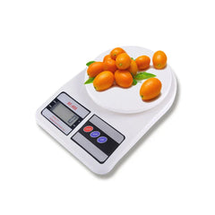 Digital Kitchen Scale - White SF-400 scale weighing fresh kumquats with leaves on its round weighing platform
