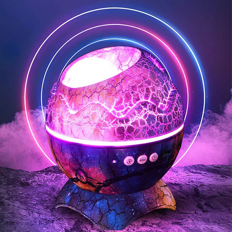 Star Projector Light - Cracked egg-shaped projector lit with pink/purple light, surrounded by glowing neon rings, on rocky surface with fog