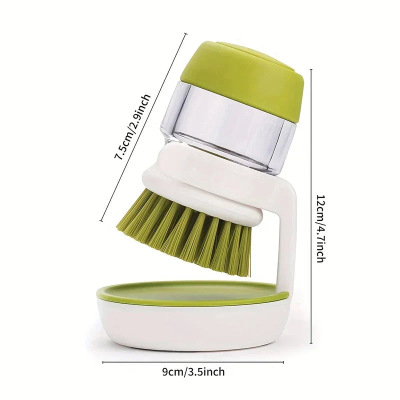 Green and white soap dispensing dish brush on its stand, with size dimension lines marked on a white background