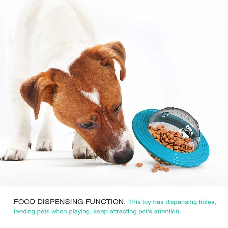 Brown and white dog sniffing spilled kibble from a tilted dog chew ball, with food dispensing function text below