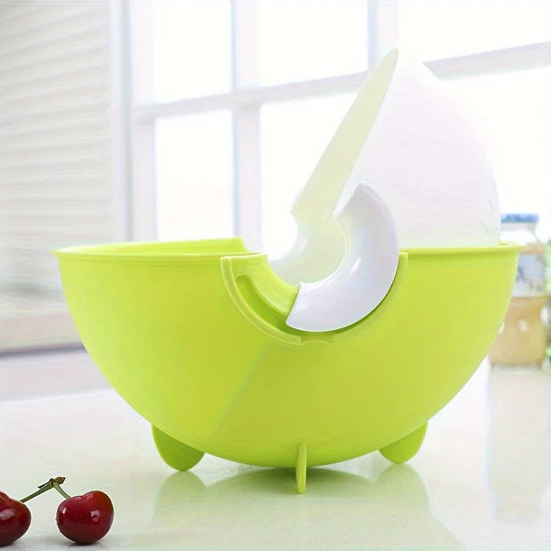 Colander Bowl Set - Two-toned bowl set tilted to drain water, sitting on a countertop with two cherries nearby