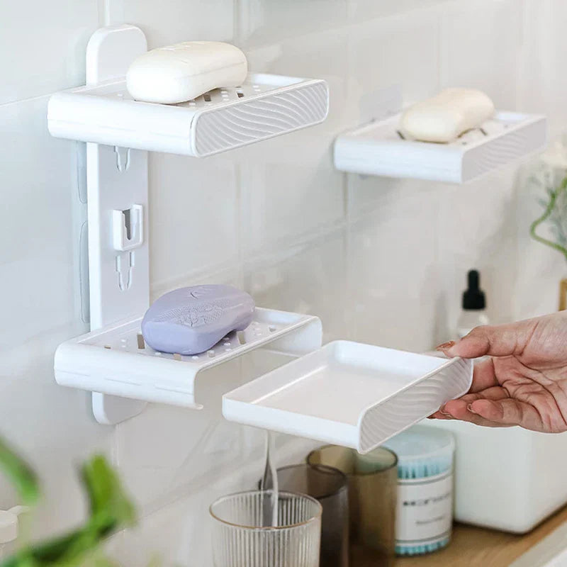 Soap Dish Holder - Hand removing the lower drainage tray from a wall-mounted two-tier soap holder to empty collected water