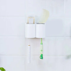 Cup Holder Set - Wall-mounted organizer holding two toothbrushes, with cups placed in upper slots and small items stored in top compartments