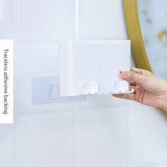 Cup Holder Set - Hand positioning the organizer onto a clear adhesive wall mount, showing built-in hanging hooks on the unit base